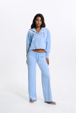 Displays a model wearing the Powder Blue 'Juicy' branded Old Gothic Oversized Cropped Hoodie 