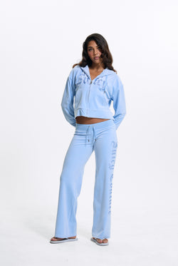 Displays a model wearing the Powder Blue 'Juicy' branded Old Gothic Oversized Cropped Hoodie 