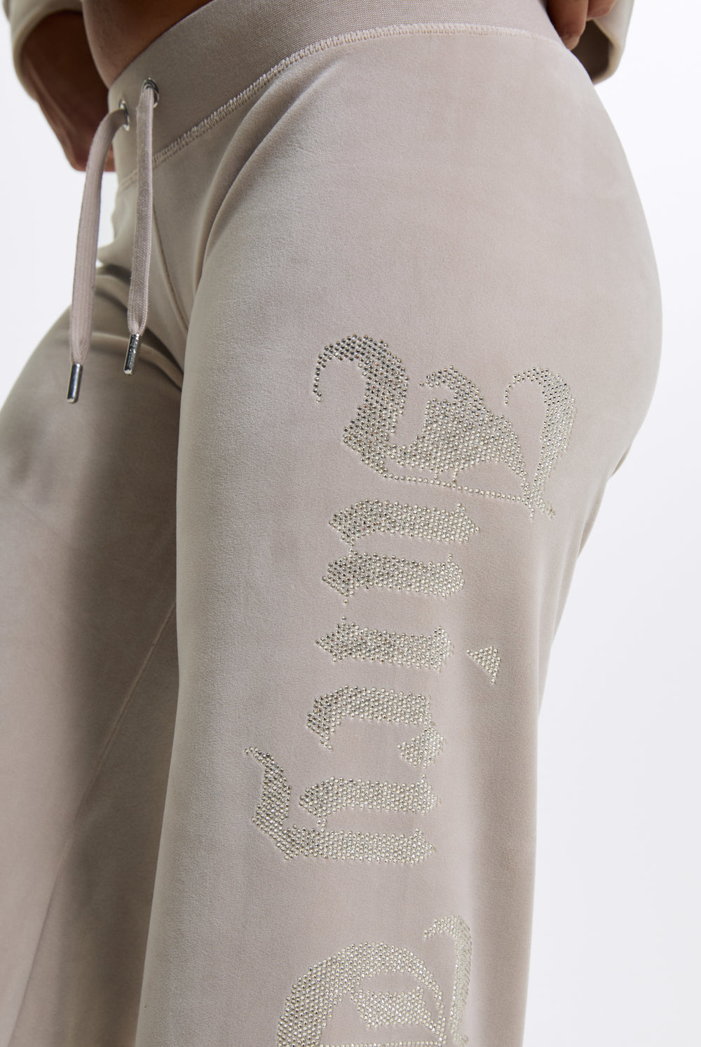 Displays a model wearing the String 'Juicy' branded Old Gothic Diamante Og Straight Leg Trackpant featuring close up on the details 