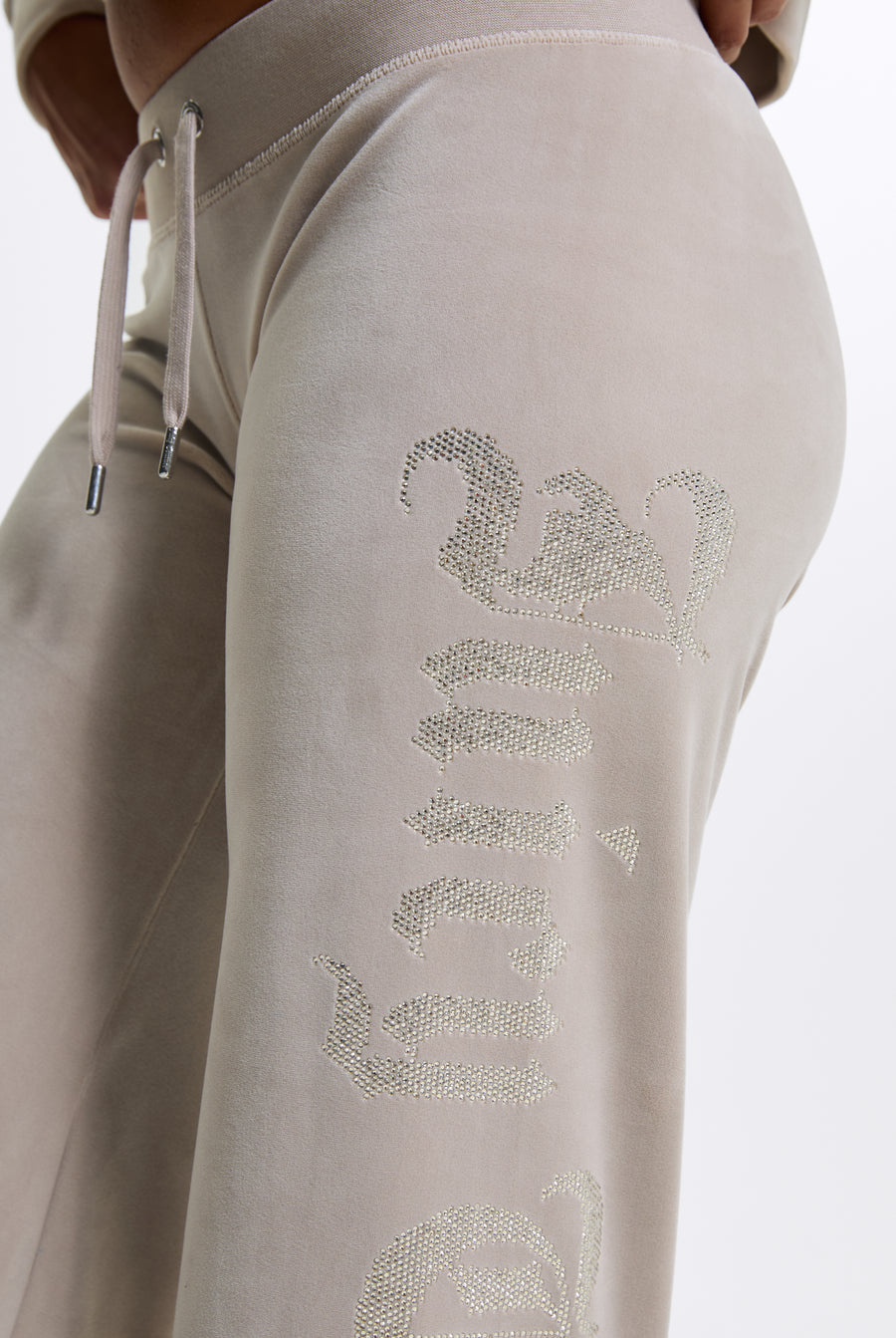 Displays a model wearing the String 'Juicy' branded Old Gothic Diamante Og Straight Leg Trackpant featuring close up on the details 