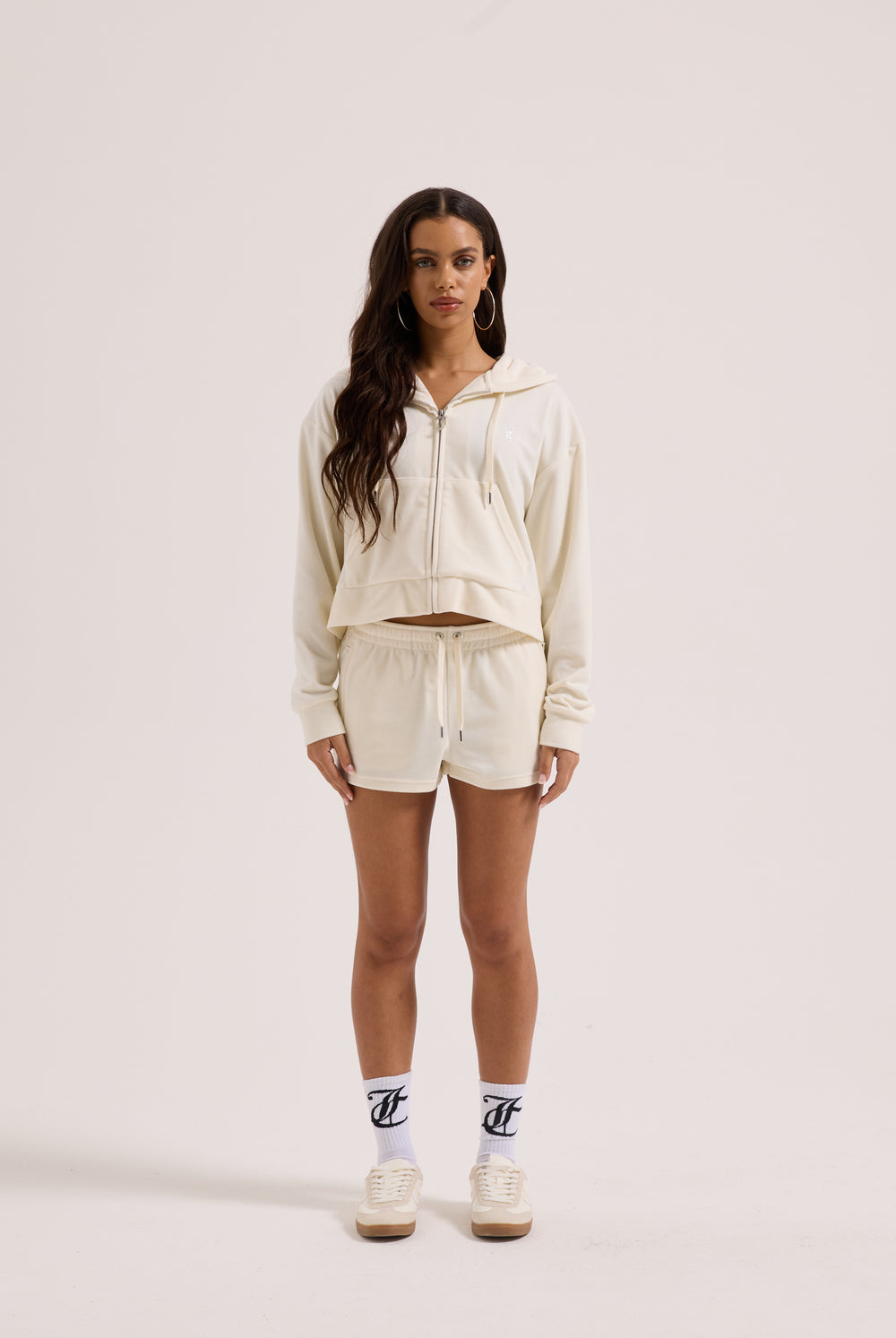 Displays a model wearing the Cream Outline 'Juicy' branded diamanté oversized cropped hoodie