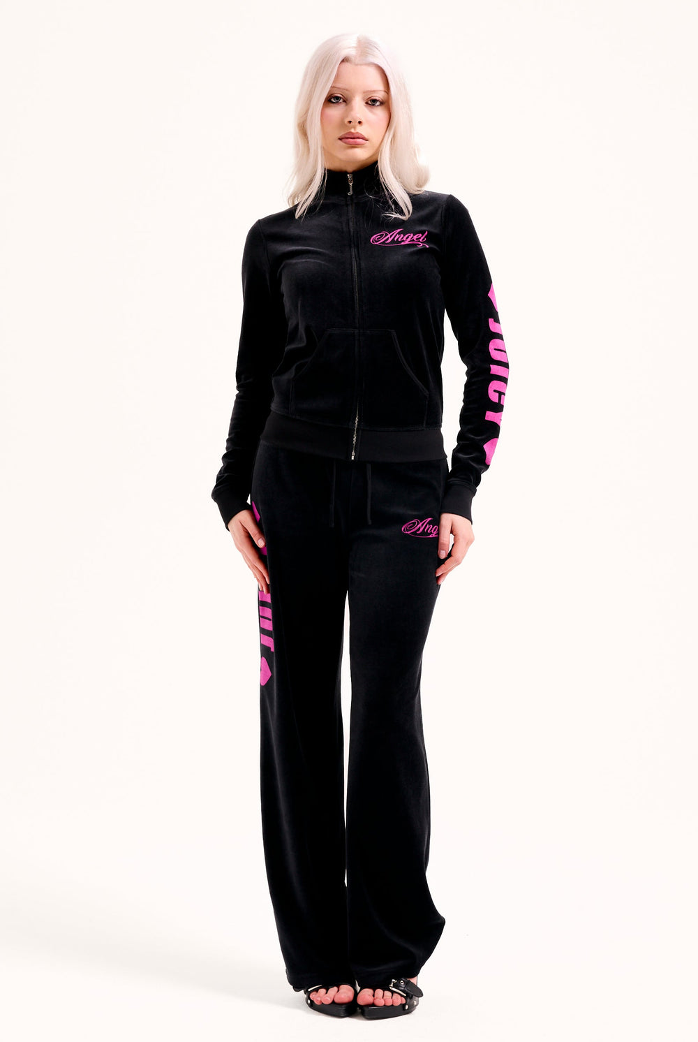 Displays a model wearing the Black 'Juicy' branded angel cotton velour track top