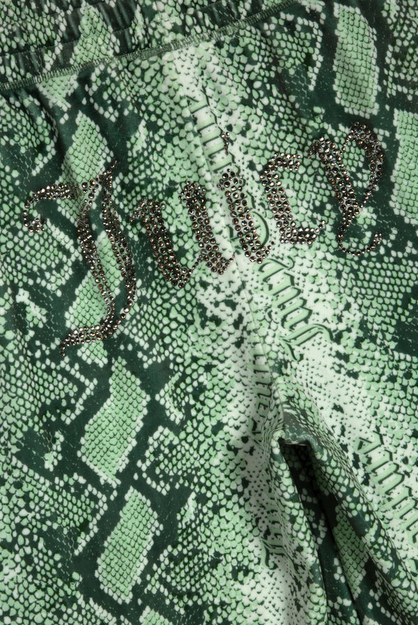 Displays the green snake print 'Juicy' branded diamanté low rise track bottom featuring the juicy branding