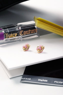 Displays some accessories featuring the the 'Juicy' Gold Tone Enamel Icon Heart Stud Earrings