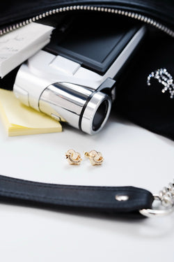 Displays some accessories featuring the 'Juicy' Gold Tone Icon Heart Stud Earrings 