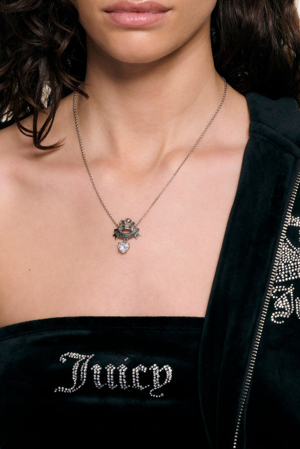 Displays a model wearing the Silver crown & crystal 'Juicy' branded heart drop pendant necklace 