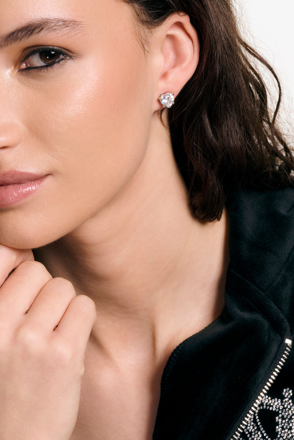 Displays a model wearing the Silver Tone 'Juicy' branded solitaire crystal heart stud earrings