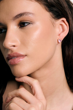 Displays a model wearing the Gold Tone 'juicy' branded solitaire crystal heart stud earring 