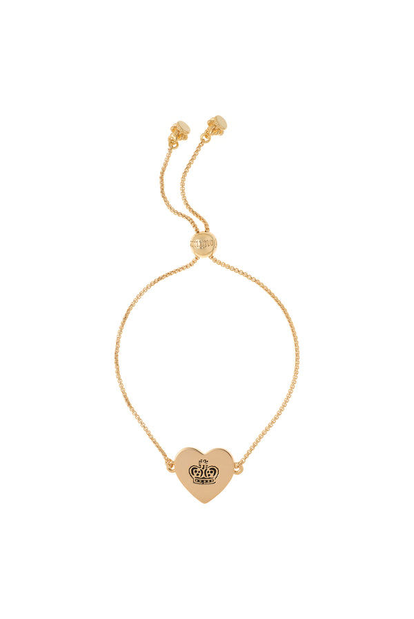 Displays the gold tone 'Juicy' branded juicy Couture reversible heart adjustable bracelet 