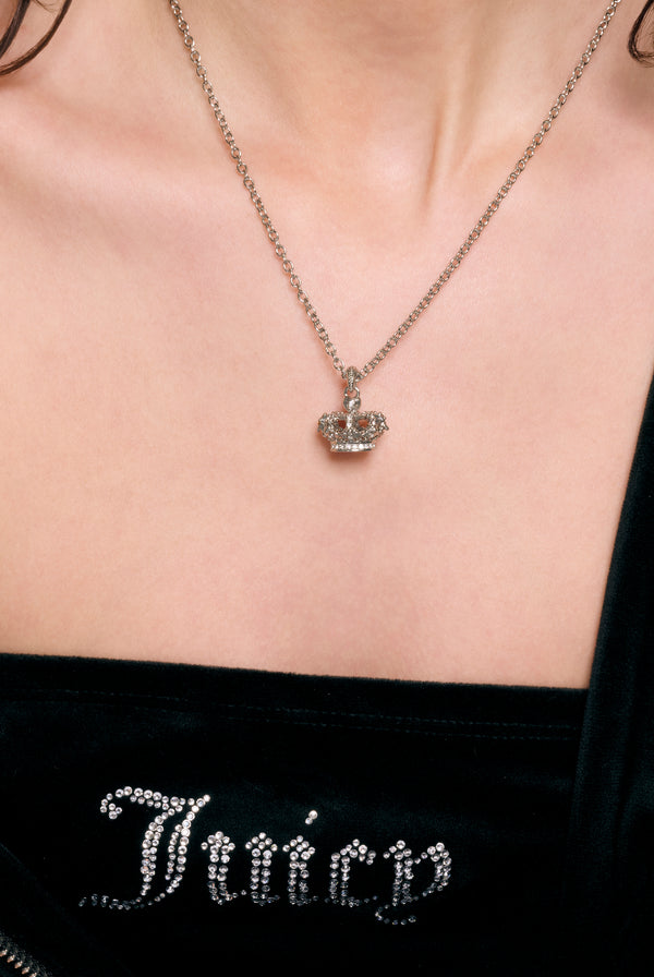 Displays a model wearing the Silver Tone 'Juicy' branded crystal heritage crown pendant 