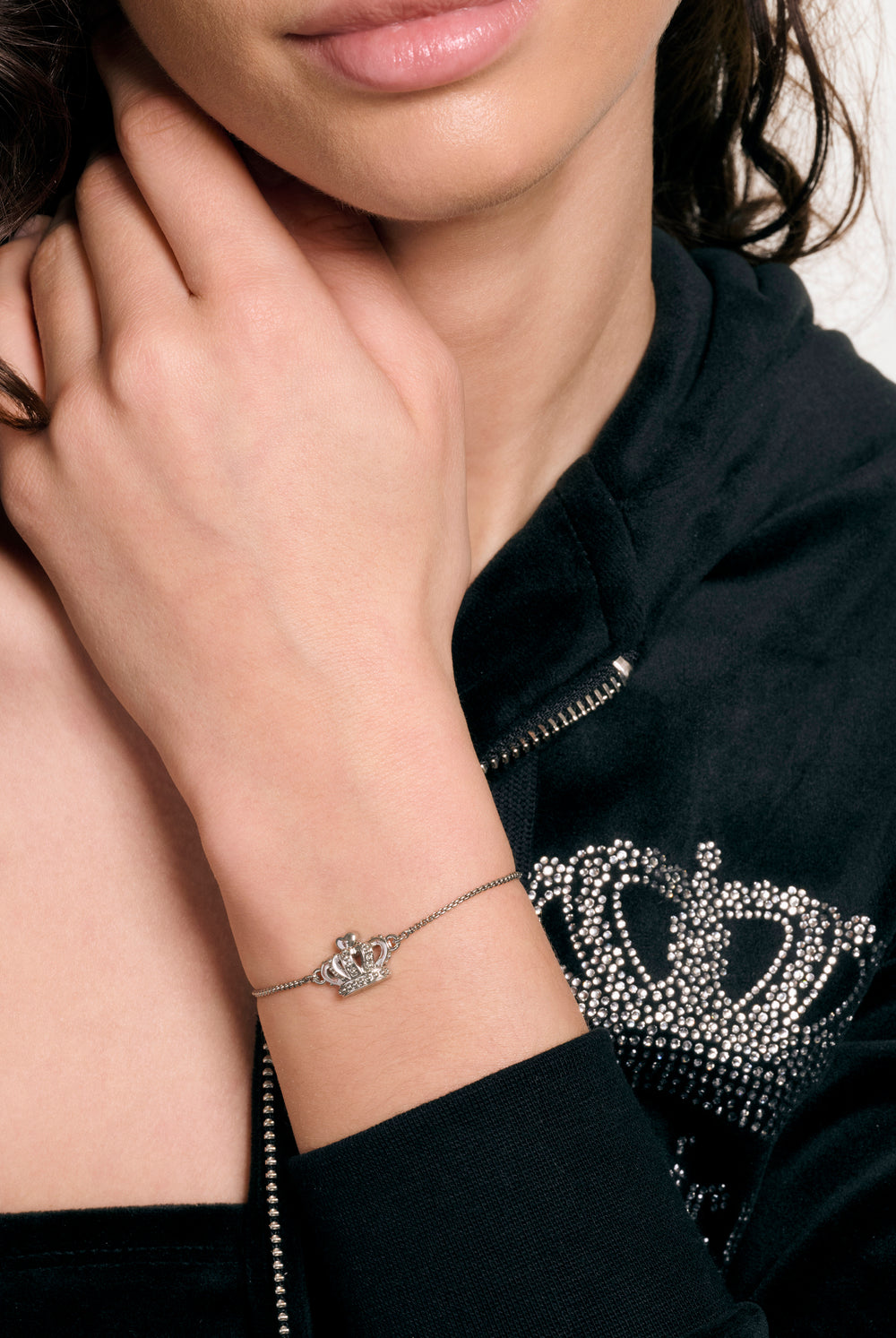 Displays a model wearing the Silver tone 'Juicy' branded icon crown adjustable bracelet 