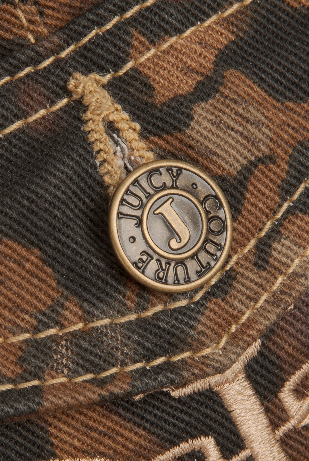 Displays the Animal 'Juicy' branded low rise flared jeans featuring the juicy Couture branding on the button