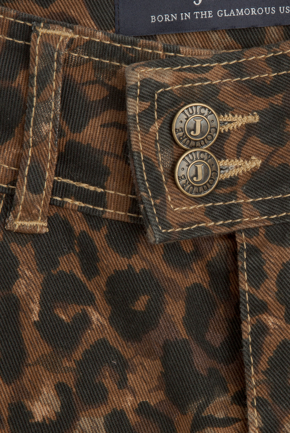 Displays the Animal 'Juicy' branded low rise flared jeans featuring the close up on the details 