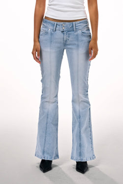 Displays a model wearing the Light wash 'juicy' branded low rise flared embodied jeans 