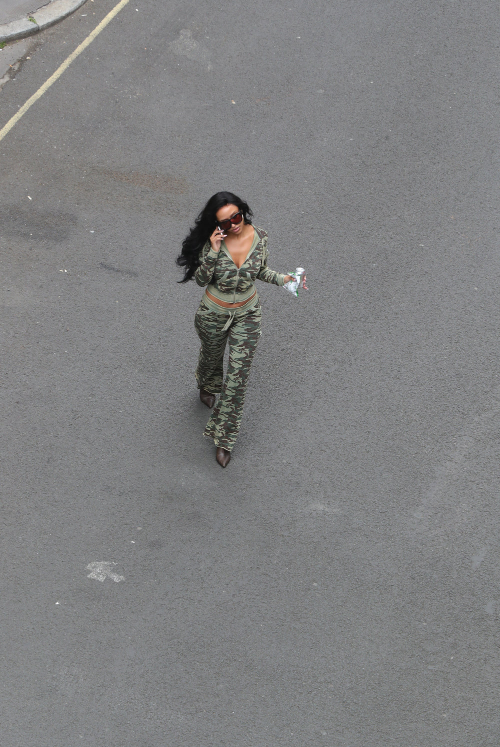 Displays a model wearing the Camo Print 'Juicy' branded washed cotton hoodie 