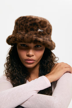 Displays a model wearing the Leopard Print 'Juicy' branded Plaque Fur Bucket Hat