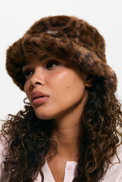 Displays a model wearing the Leopard Print 'Juicy' branded Plaque Fur Bucket Hat
