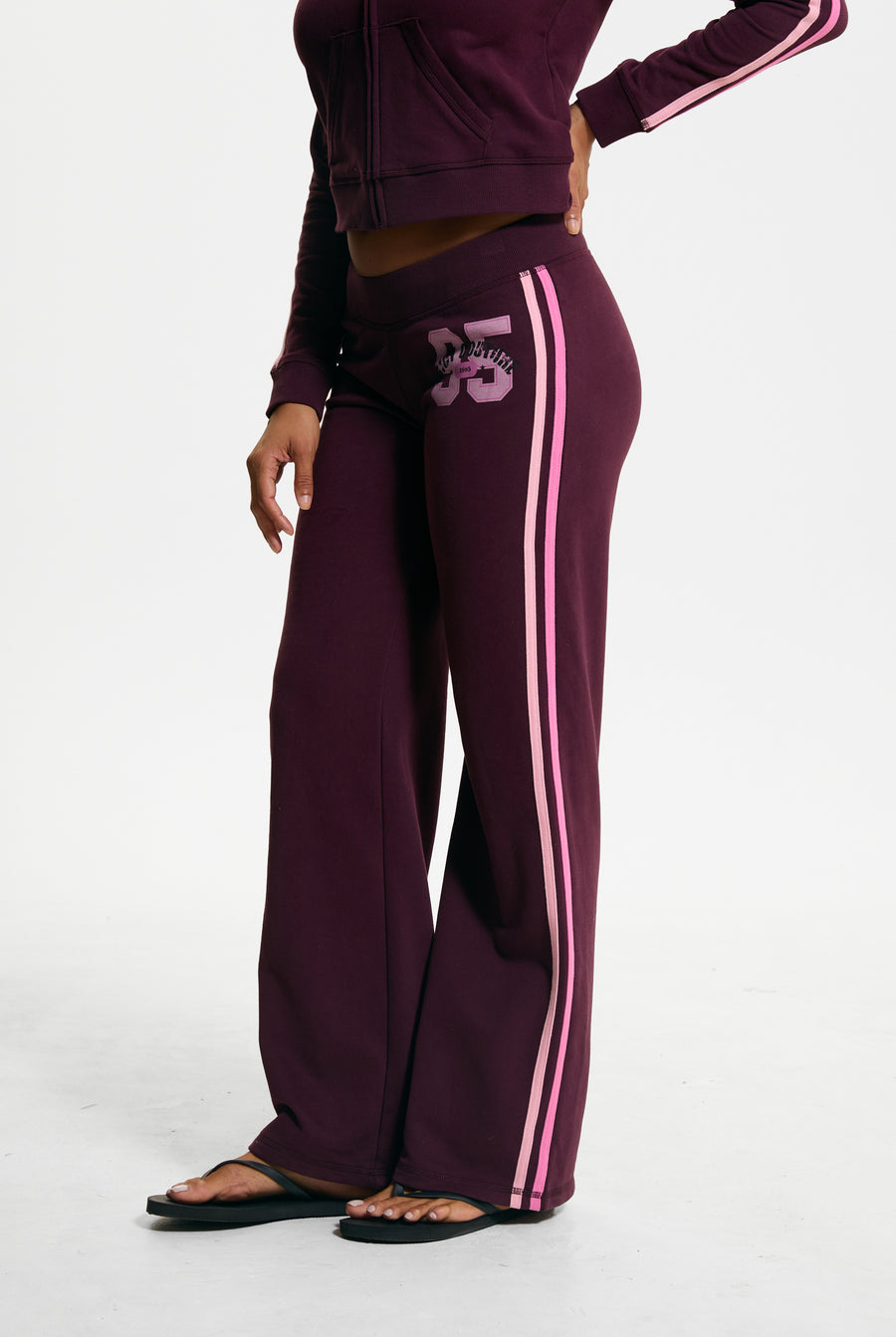 Displays a model wearing the Winetasting 'Juicy' branded Juicy Sport 95 Trackpant