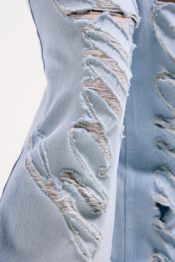 Displays the Bleached 'Juicy' branded denim distressed wide leg jeans featuring the juicy branding 
