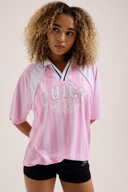 Displays a model wearing the Cherry Blossom 'Juicy' branded football polo shirt