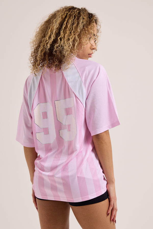 Displays a model wearing the Cherry Blossom 'Juicy' branded football polo shirt