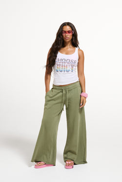 Displays a model wearing the White 'Juicy' branded Choose juicy vest top 