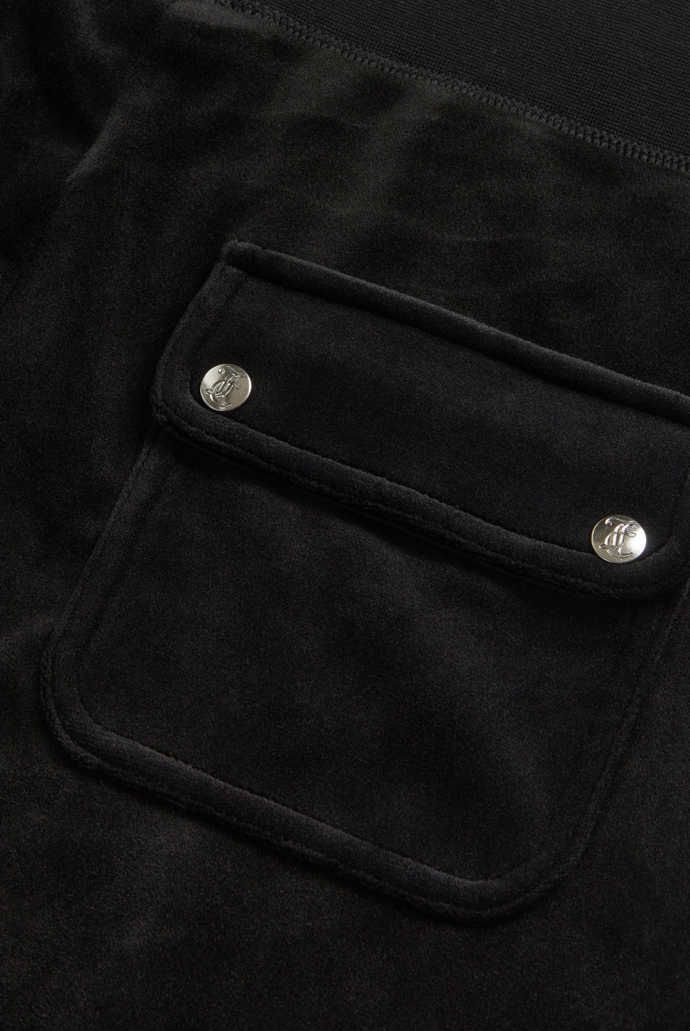 Displays the Black Low rise flare pocket 'Juicy' branded classic velour track pant featuring the pocket 