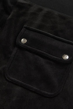 Displays the Black Low rise flare pocket 'Juicy' branded classic velour track pant featuring the pocket 