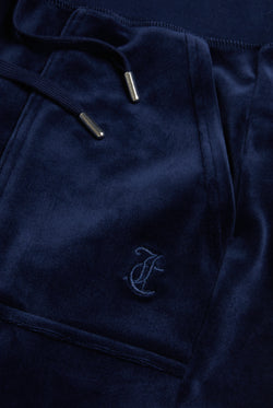 Displays the Night Sky 'Juicy' branded low rise velour track pants featuring the juicy Logo