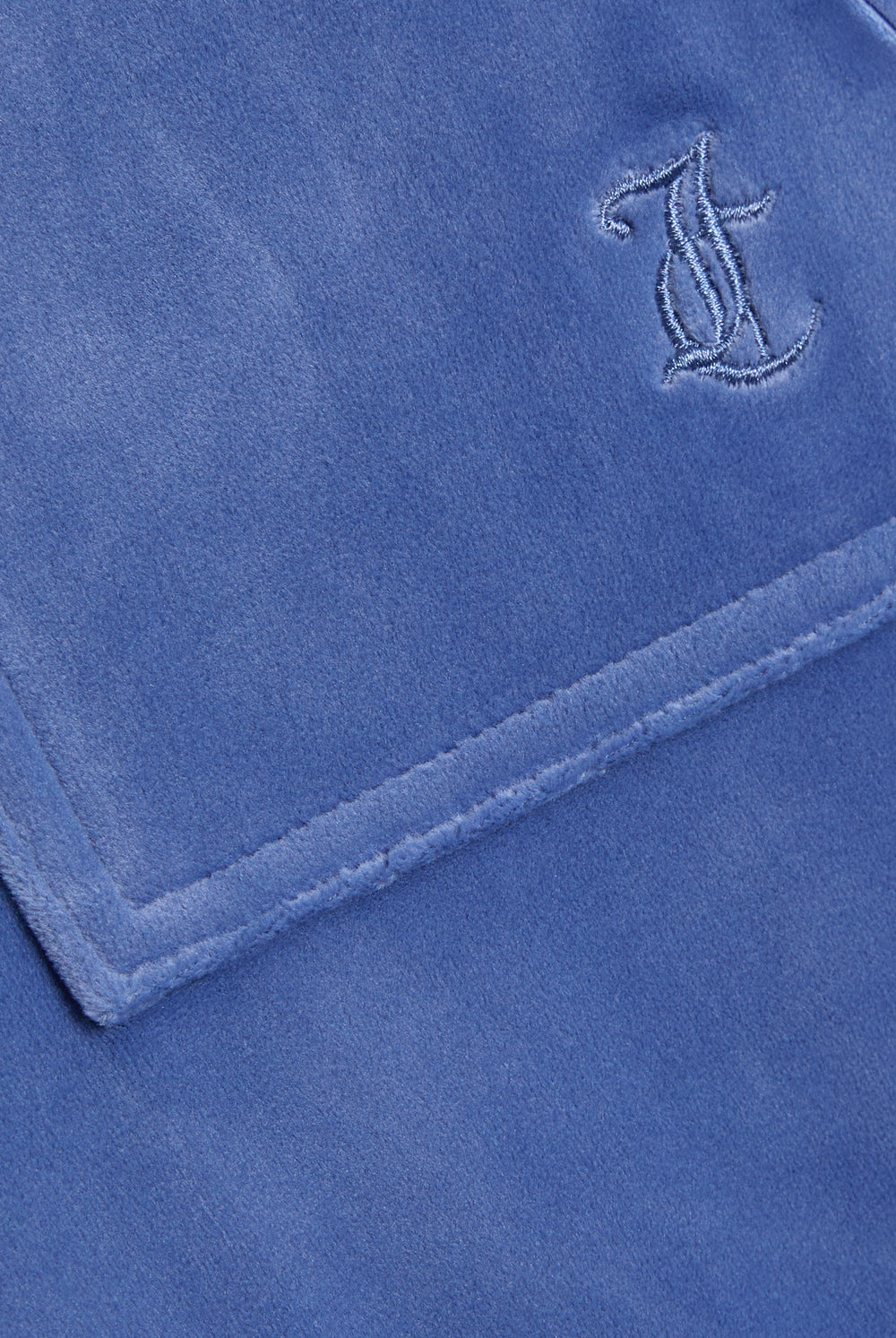 Displays the Grey&blue 'Juicy' branded Low Rise Flare Classic Velour Track Pant featuring the juicy couture branding