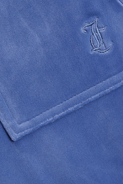 Displays the Grey&blue 'Juicy' branded Low Rise Flare Classic Velour Track Pant featuring the juicy couture branding
