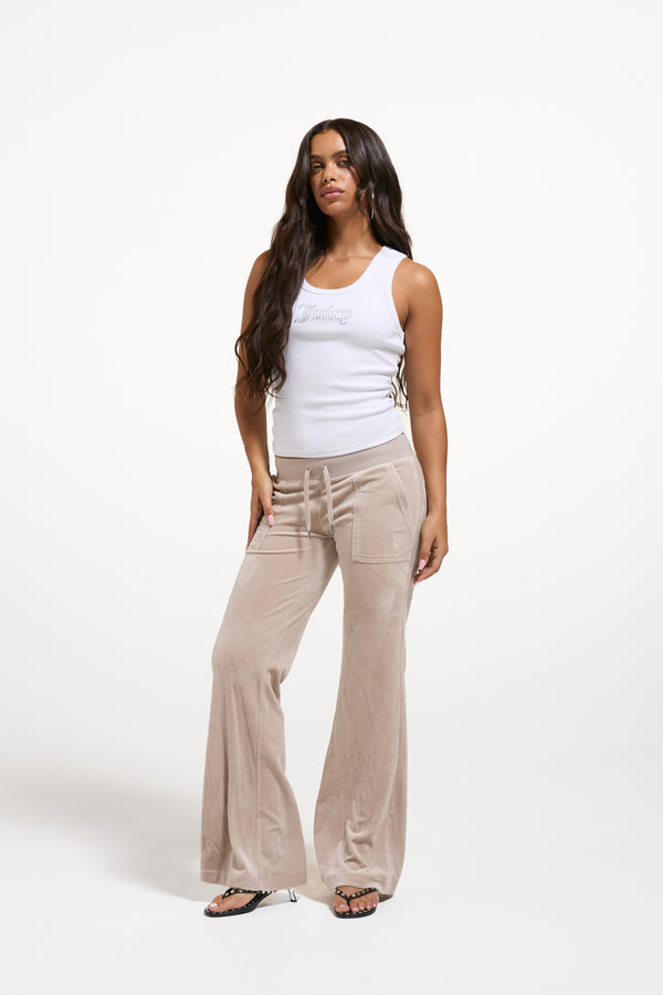 Displays a model wearing the String 'Juicy' branded low rise flare pocket classic velour track pant 