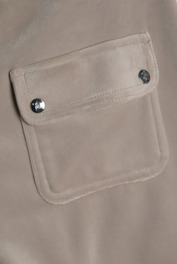 Displays the String 'Juicy' branded low rise flare pocket classic velour track pant featuring the details on the pockets