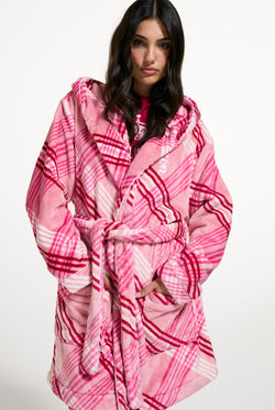 Displays a model wearing the Pink 'Juicy' branded Check Plush Robe