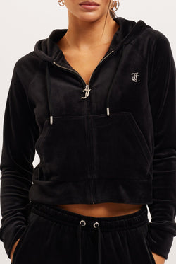 Woman wearing a black Juicy Couture hoodie on a white background
