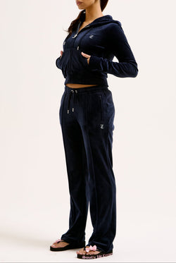 Displays a model wearing the Night Sky 'juicy' branded velour diamanté tracksuit bottom