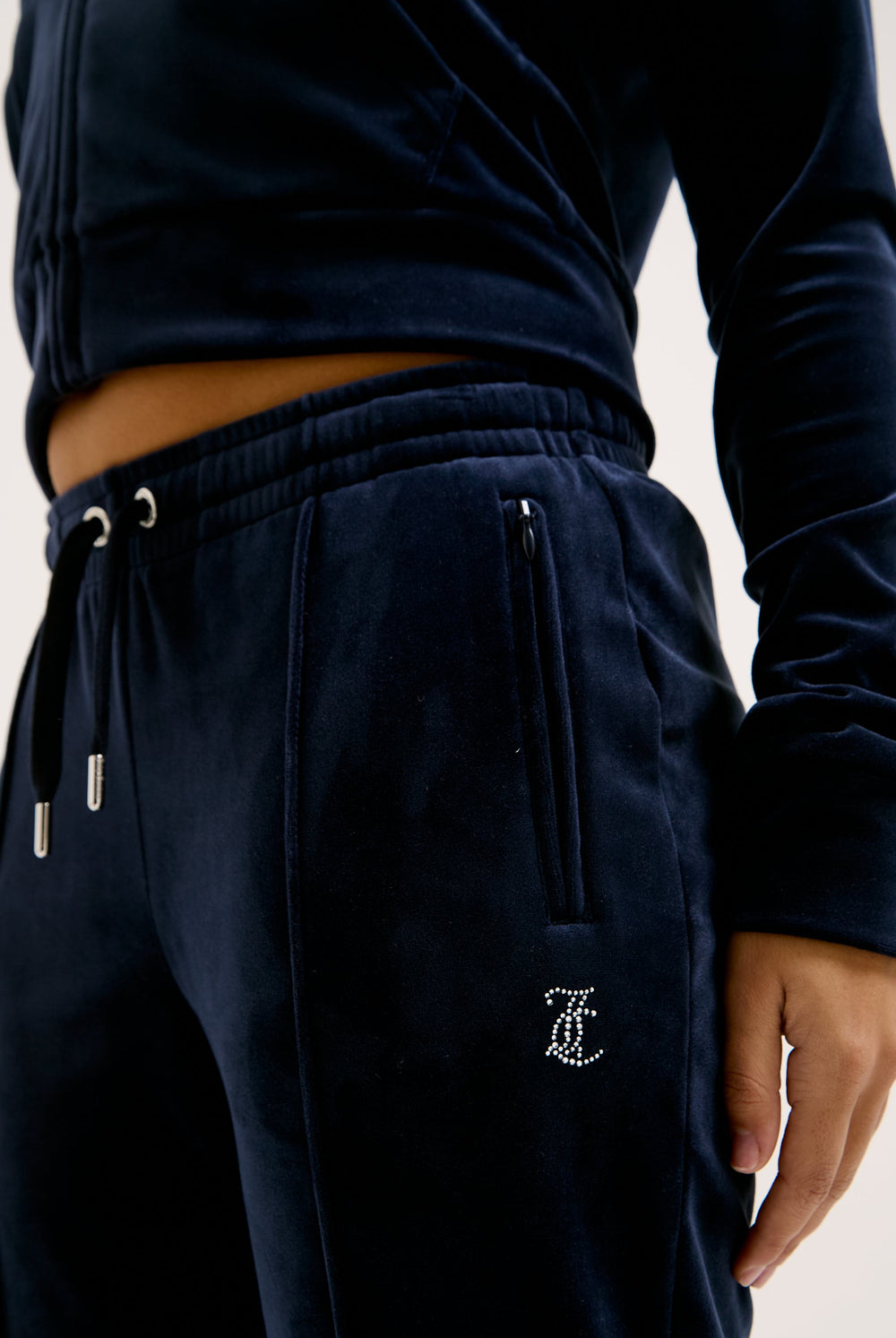Displays a model wearing the Night Sky 'juicy' branded velour diamanté tracksuit bottom