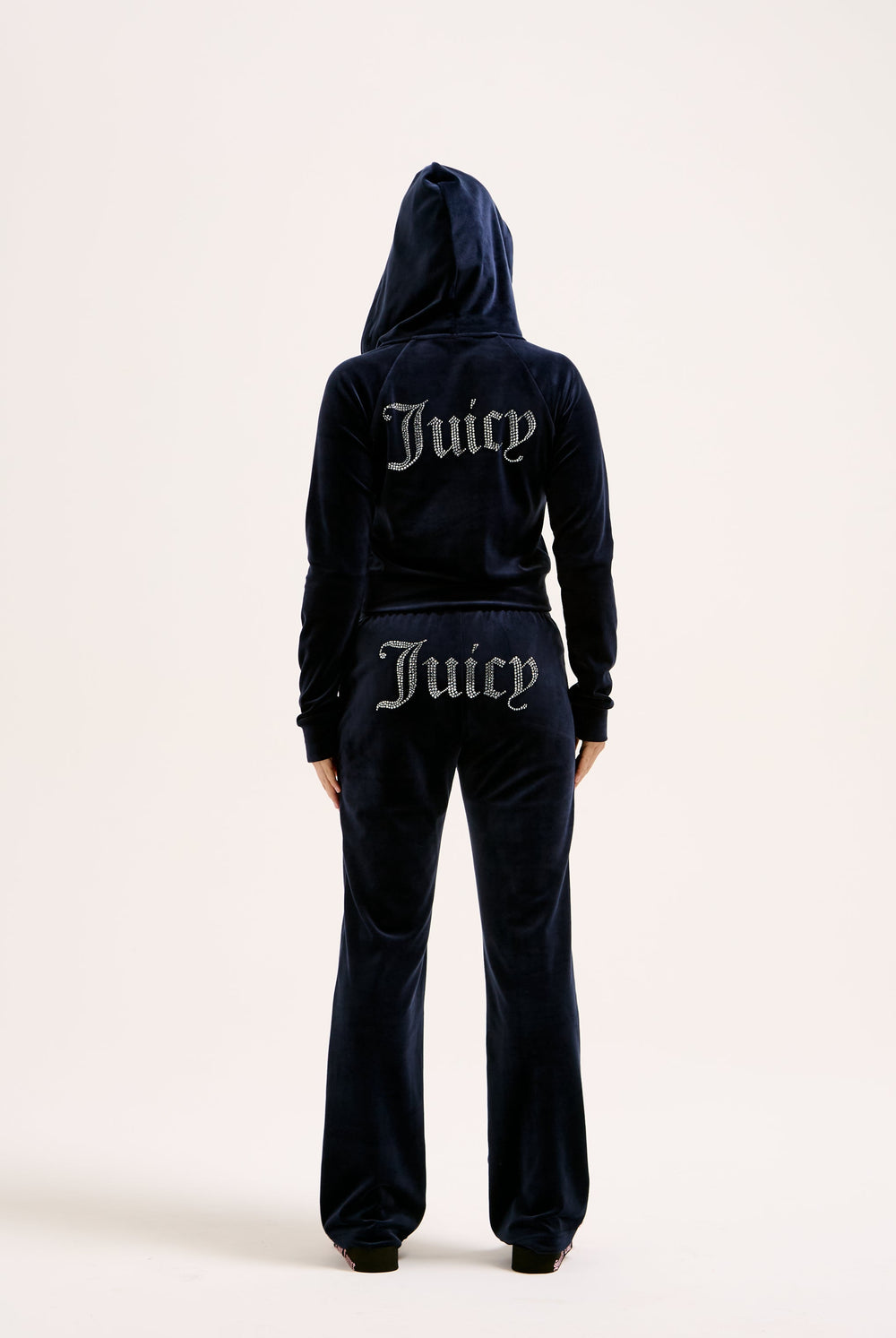 Displays a model wearing the Night Sky 'juicy' branded velour diamanté tracksuit bottom