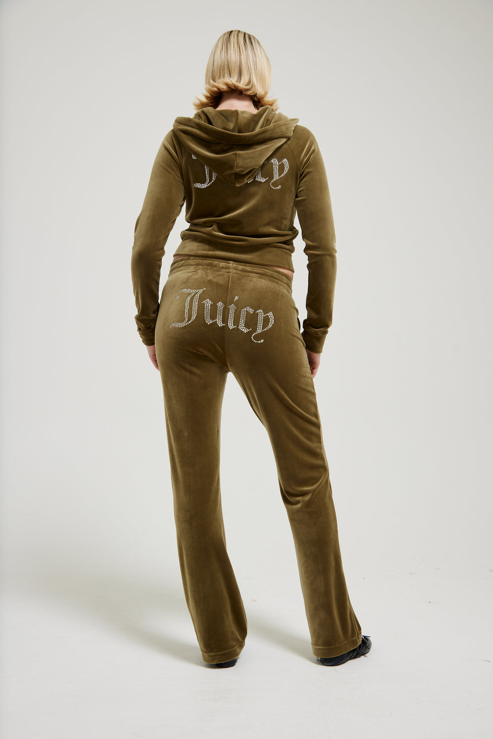 Displays the Dark Olive 'Juicy' branded velour diamanté tracksuit bottom