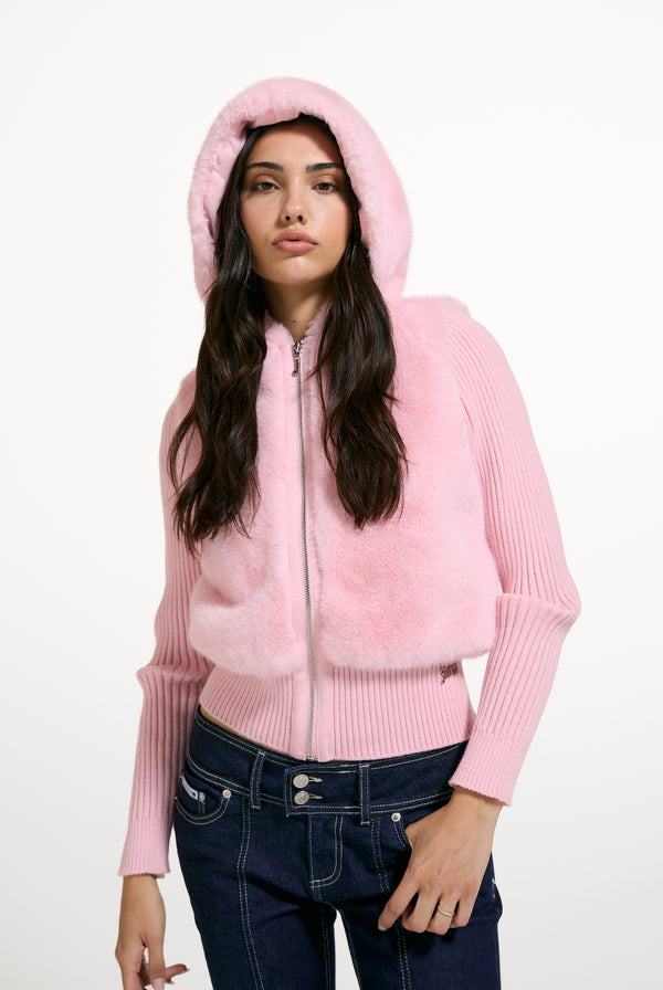 Displays a model wearing the Almond Blossom 'Juicy' branded Faux Fur Knitted Jacket
