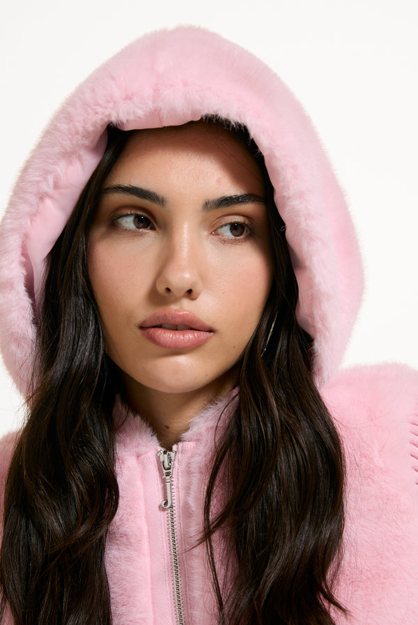 Displays a model wearing the Almond Blossom 'Juicy' branded Faux Fur Knitted Jacket