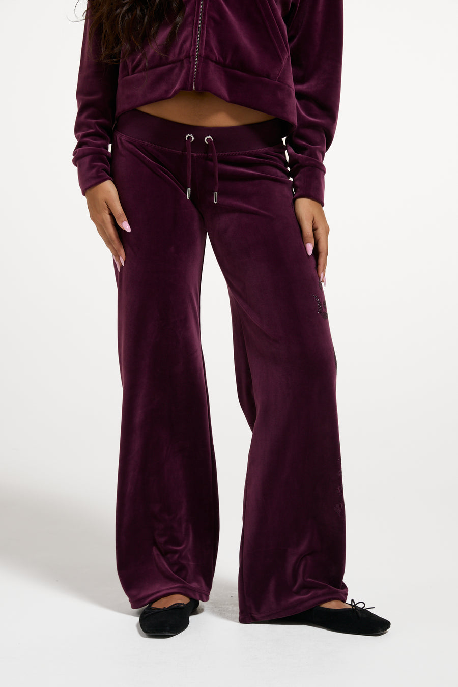 Displays a women wearing the Winetasting 'Juicy' branded Old Gothic Diamante OG Straight Leg Trackpant