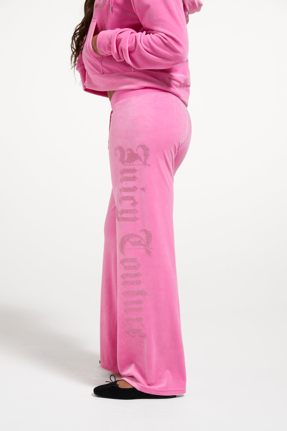 Displays a model wearing the Wild Orchid 'Juicy' branded Old Gothic Diamante OG Straight Leg Trackpant