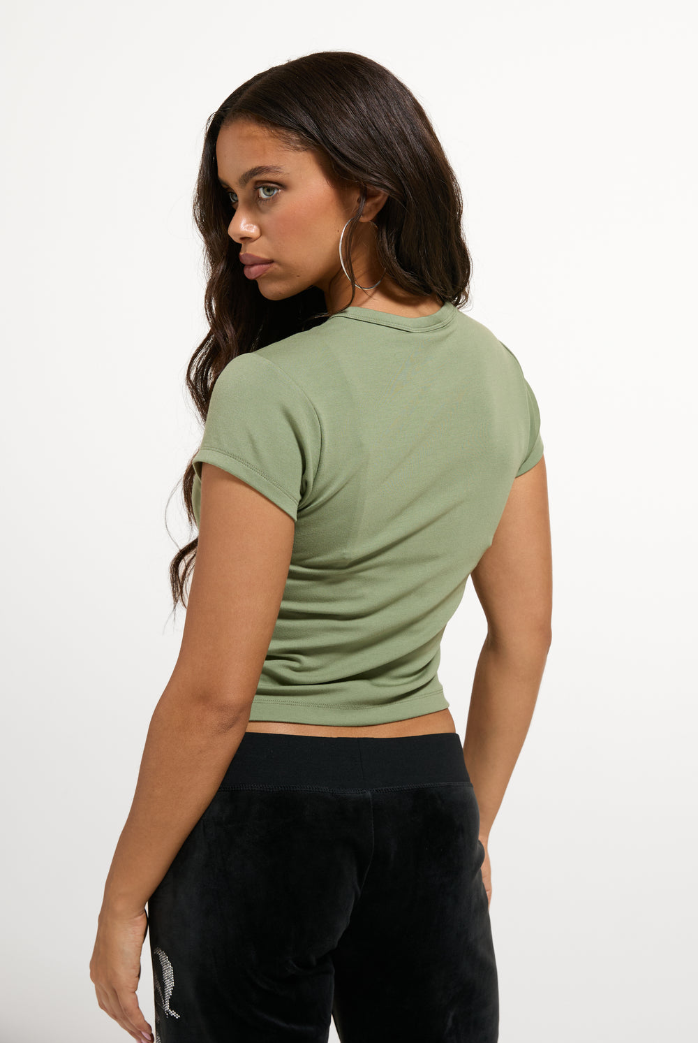 Displays a model wearing the Oil Green 'Juicy' branded Old Gothic Baby T-Shirt