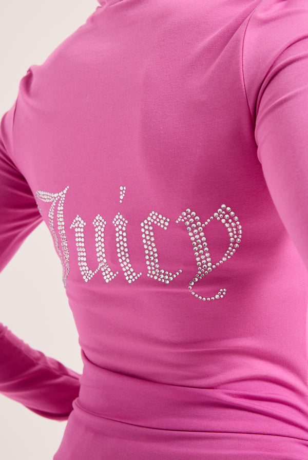 Displays a model wearing the Super Pink 'Juicy' branded Diamanté luxury jersey zip-through hoodie featuring the juicy branding 