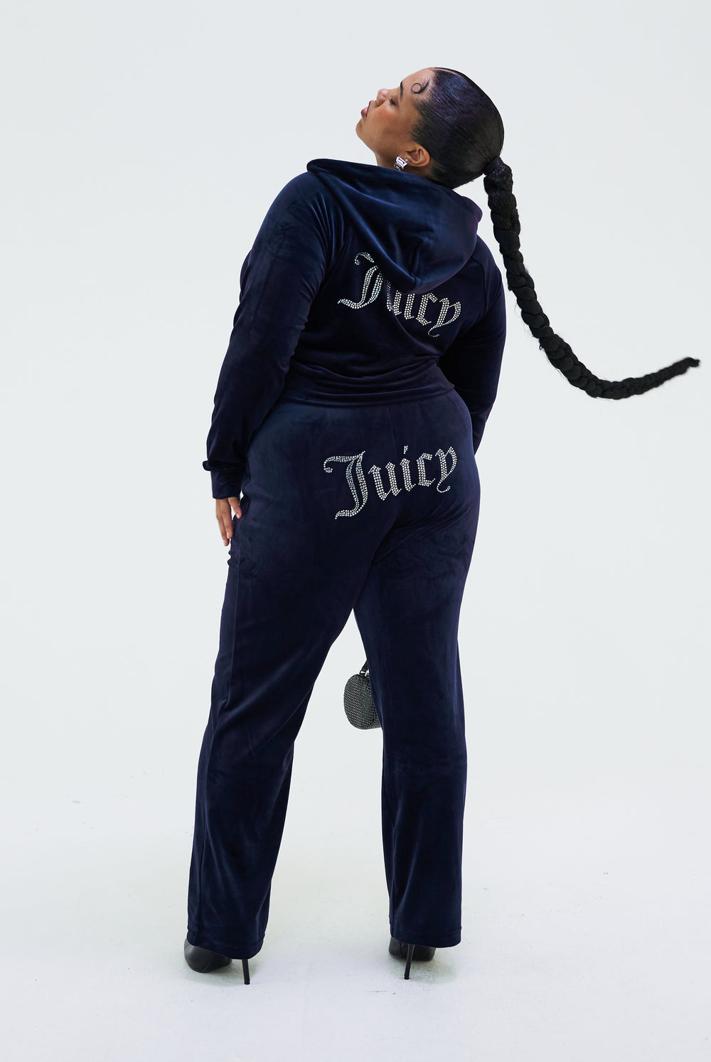 Displays a model wearing the Night Sky 'juicy' branded velour diamanté tracksuit bottom