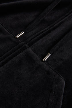 Close up of a black velour hoodie