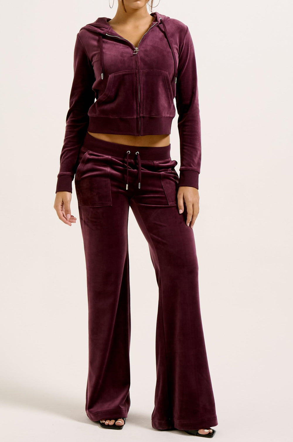 Displays a model wearing the wine tasting classic 'juicy' branded velour Robertson hoodie 