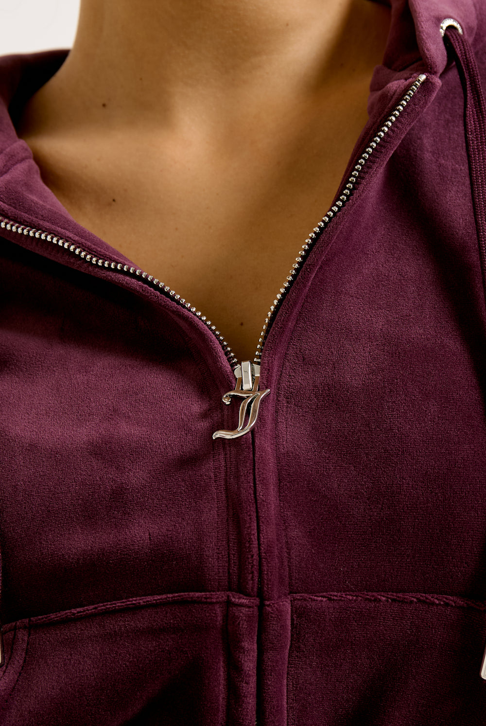 Displays a model wearing the wine tasting classic 'juicy' branded velour Robertson hoodie 