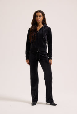 Woman wearing a black outfit on a white background